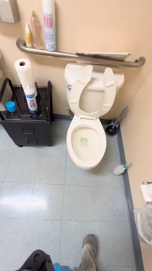 The same restroom toilet during the final rinse